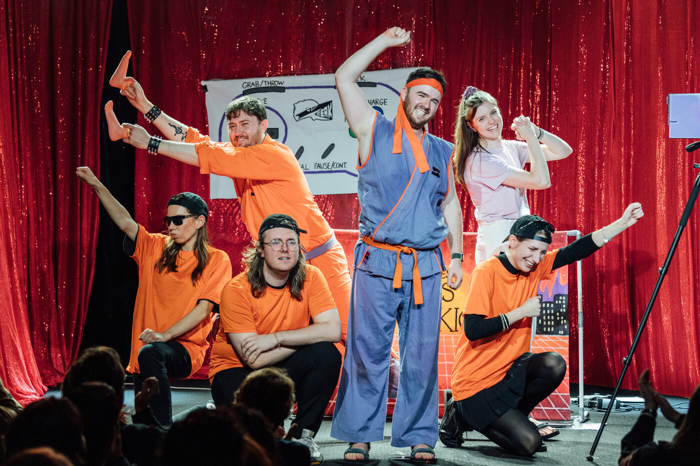 The cast of Karate Man striking a triumphant final pose onstage for the audience